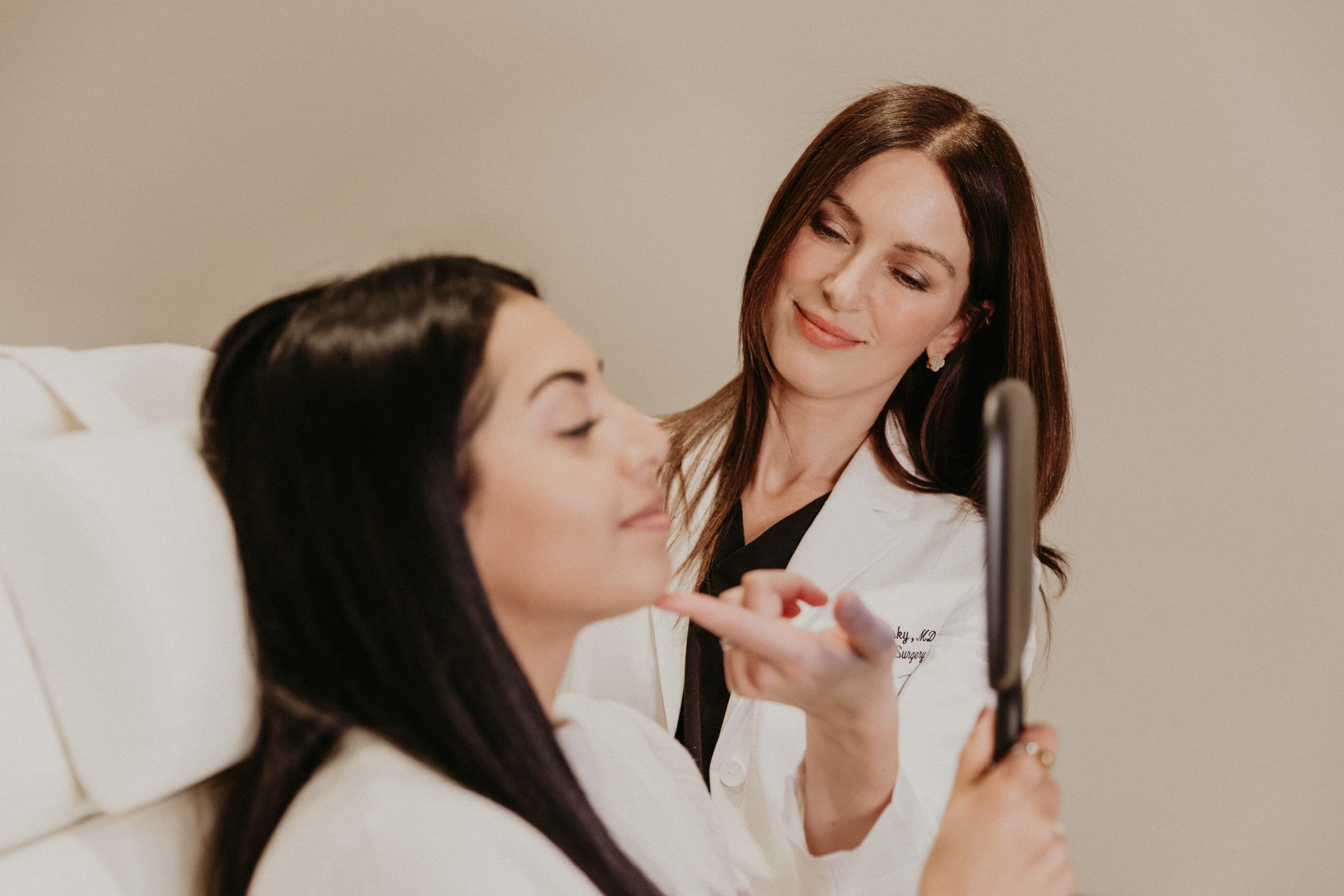 Dr. Renata Khelemsky evaluating a patient's jawline